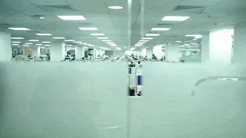 AM InfoWeb office workspace with teams working across a modern operations floor, highlighting scale and organized service delivery.